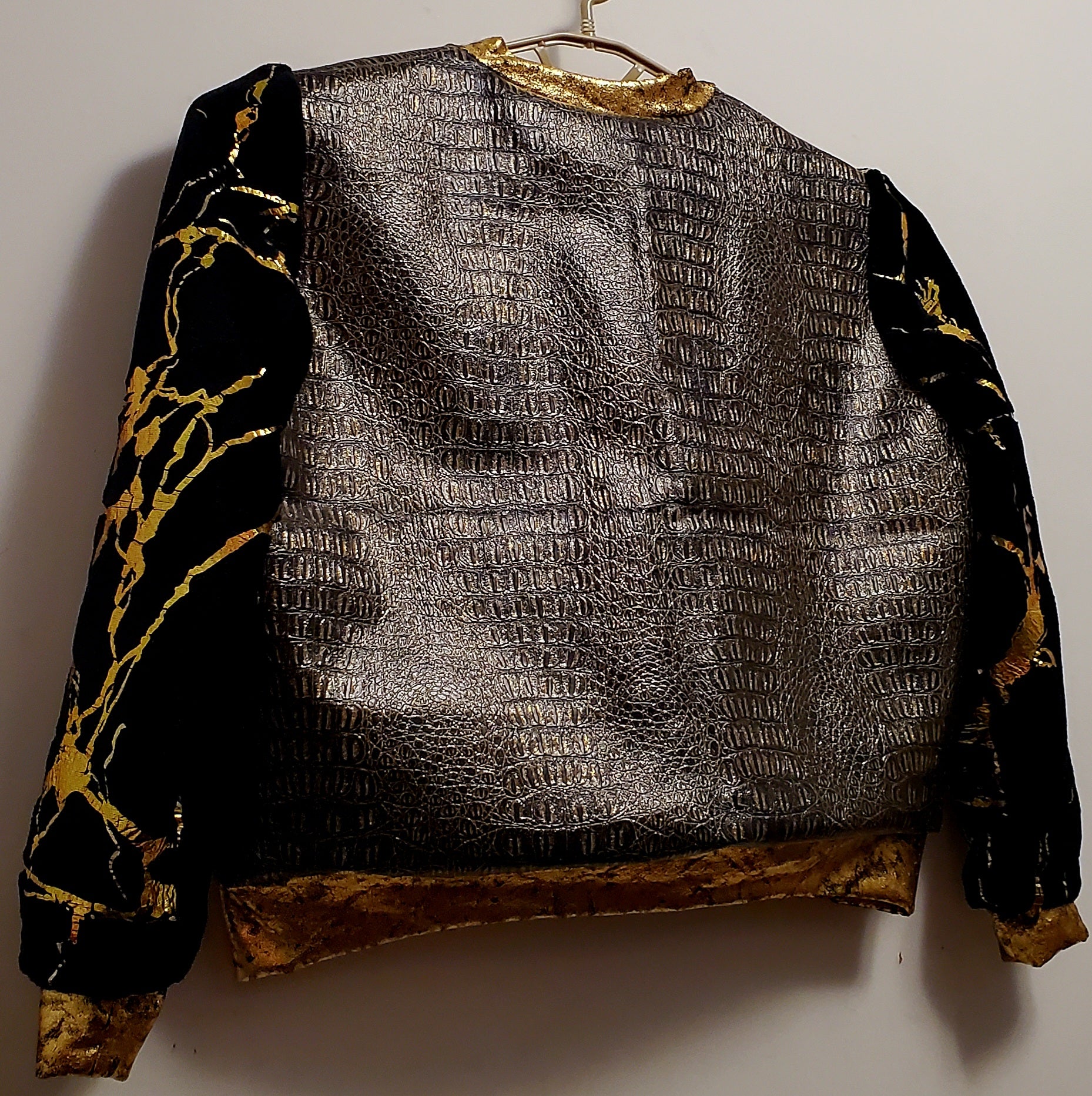 Close up view of back view of Faux alligator and marbled fur bomber jacket