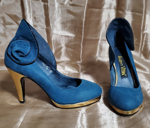 Side  and front view of Suann Villa blue and gold leather pumps with ruffle details