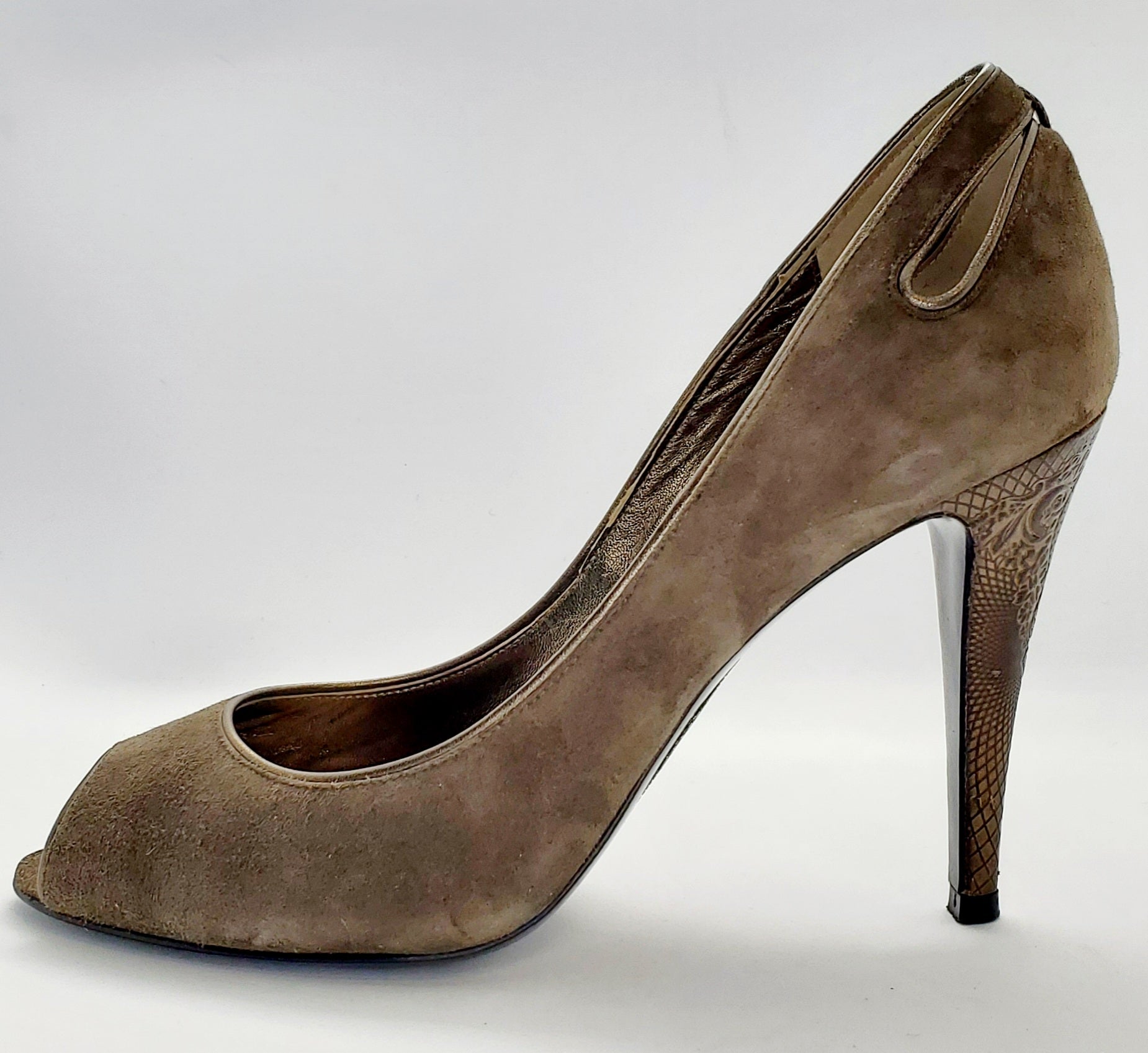 Side view of Elie Tahari Suede open toe pump with ornate patterned keyhole heels