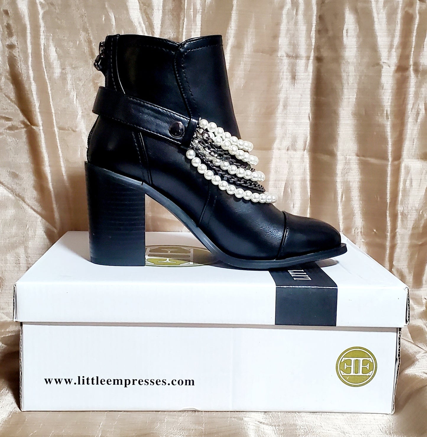 Inner side view of Black booties with pearl and chain details