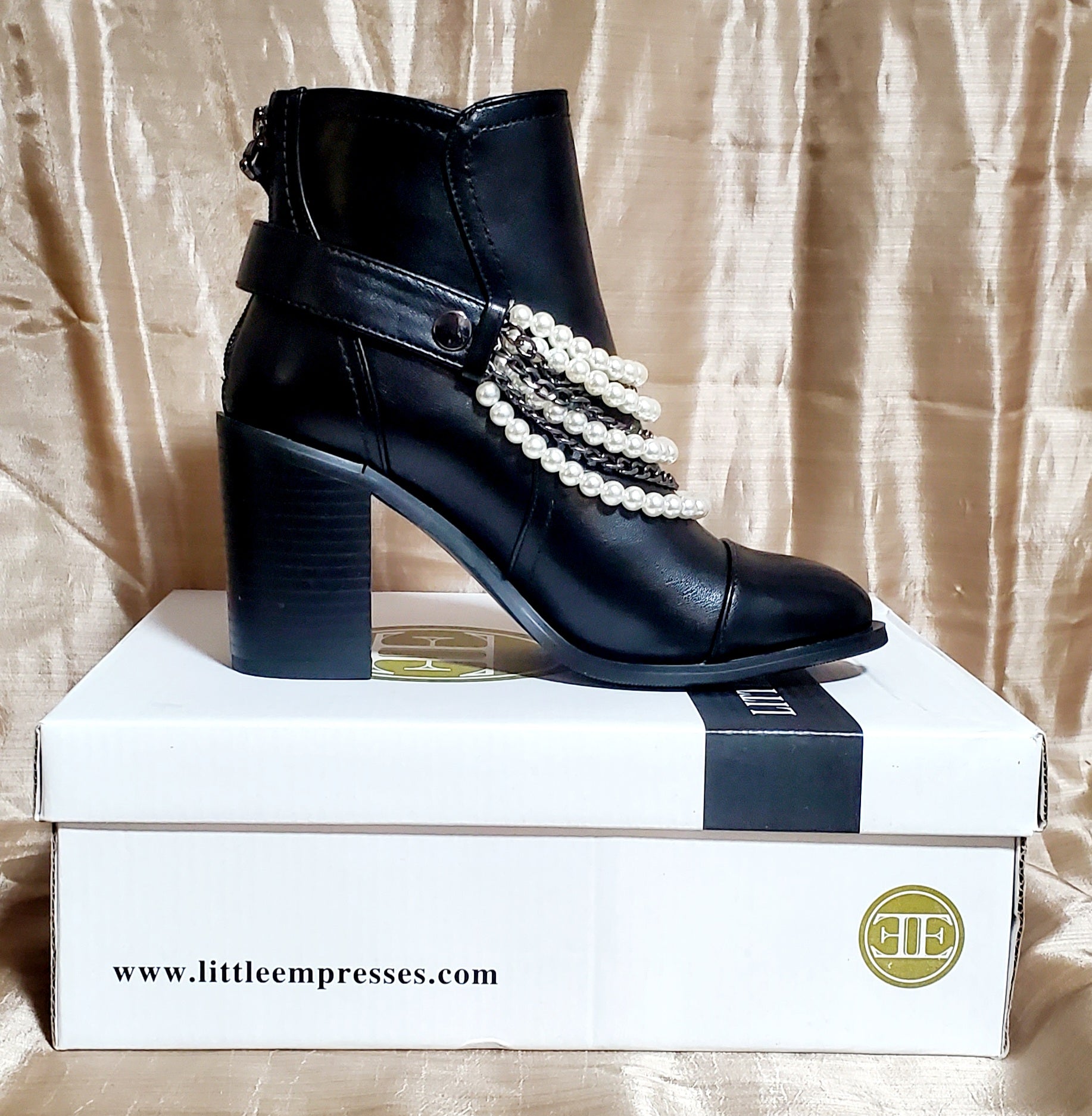 Inner side view of Black booties with pearl and chain details