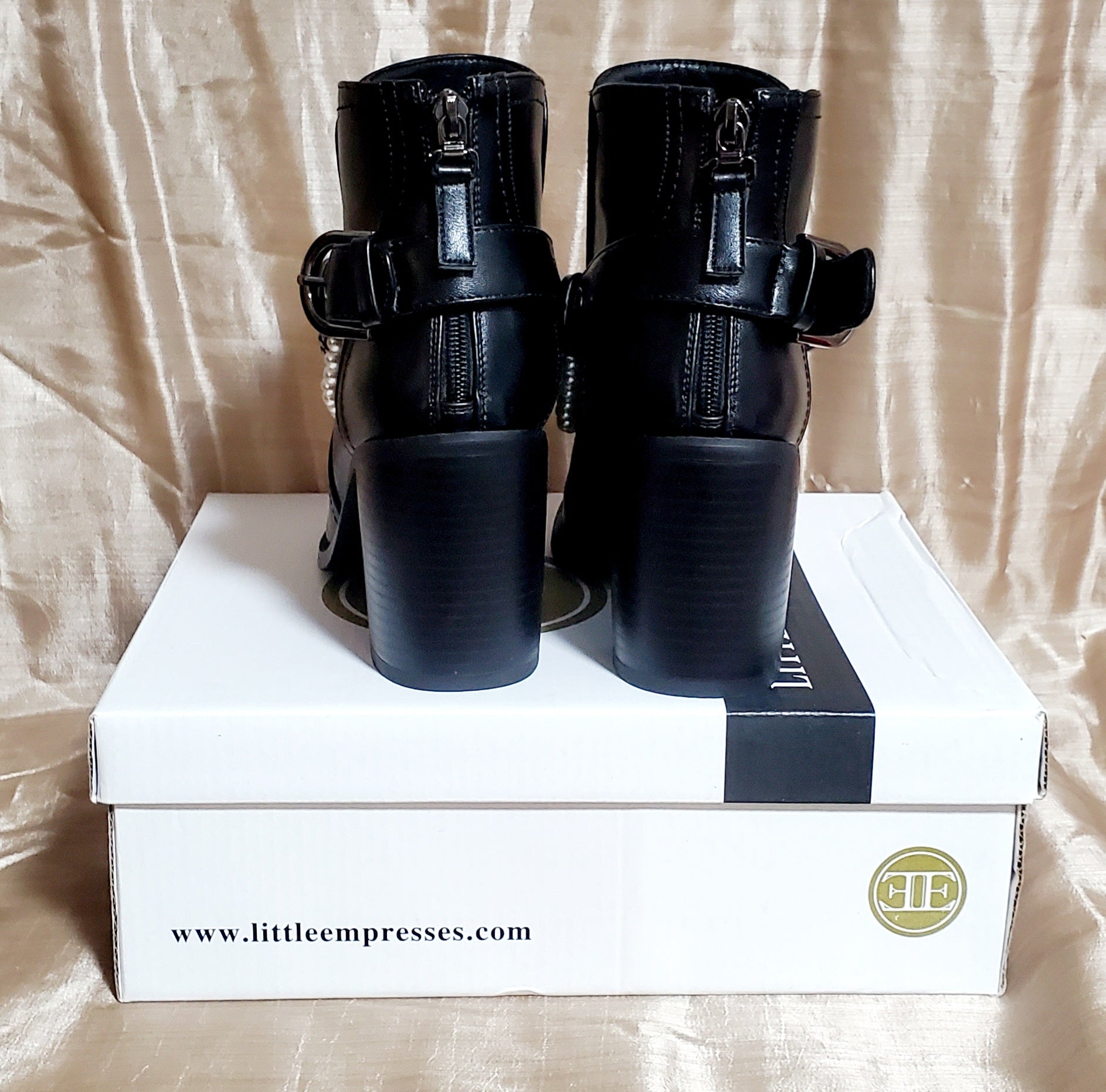 Back view of Black booties with pearl and chain details