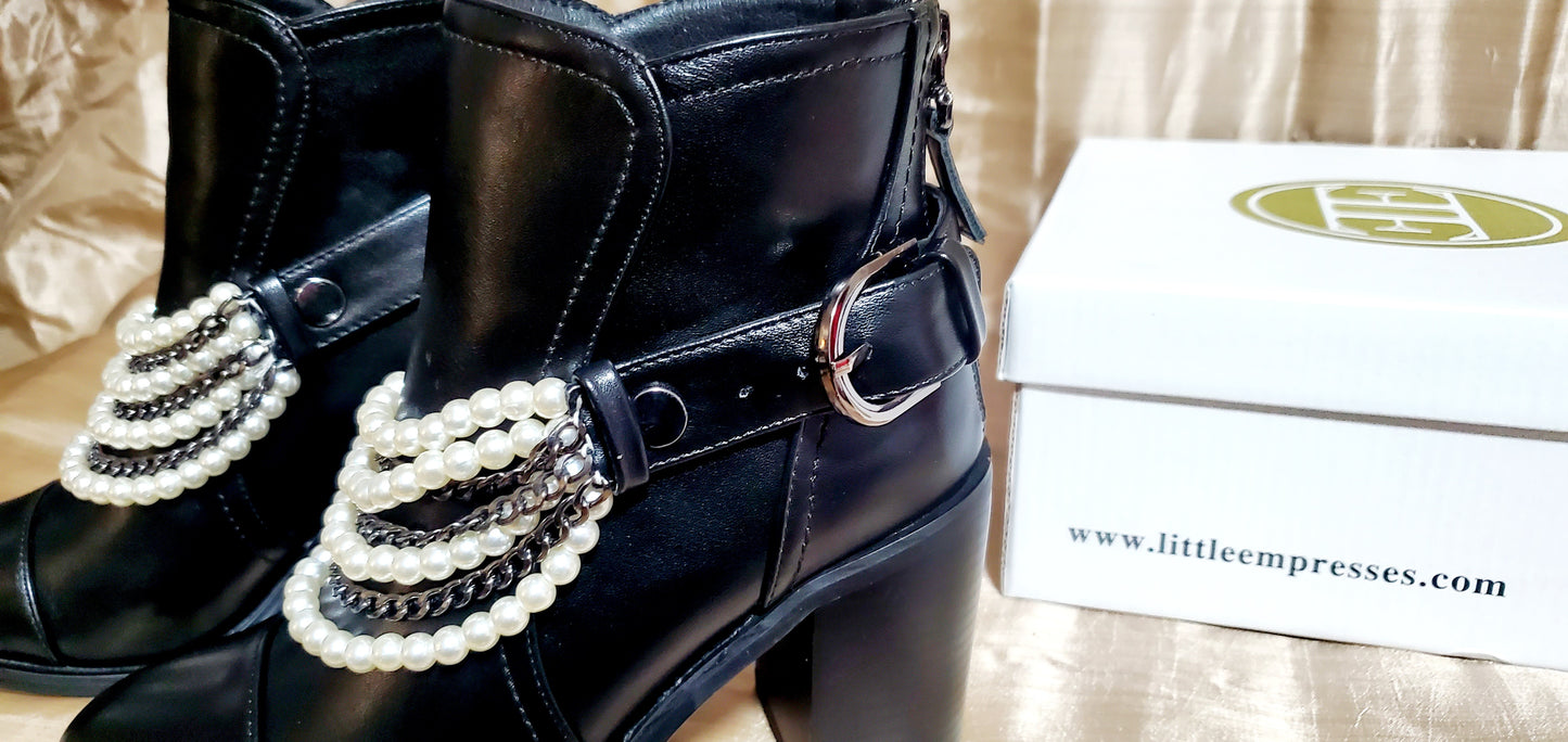 Box and side view of Black booties with pearl and chain details
