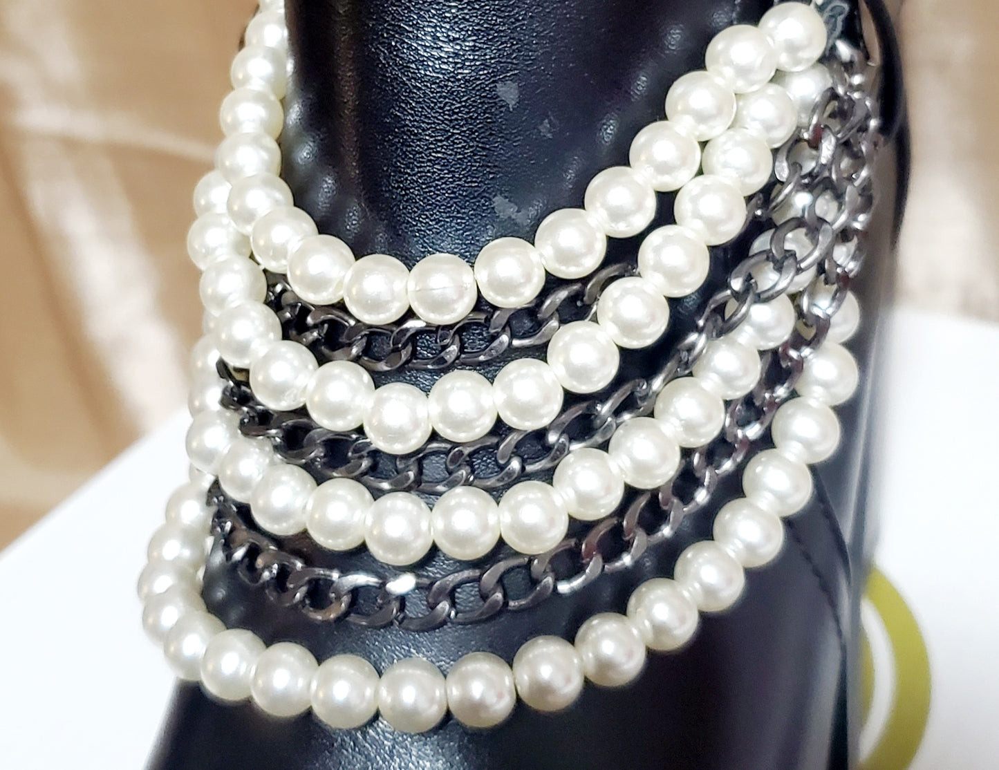 close up of pearl details on black booties