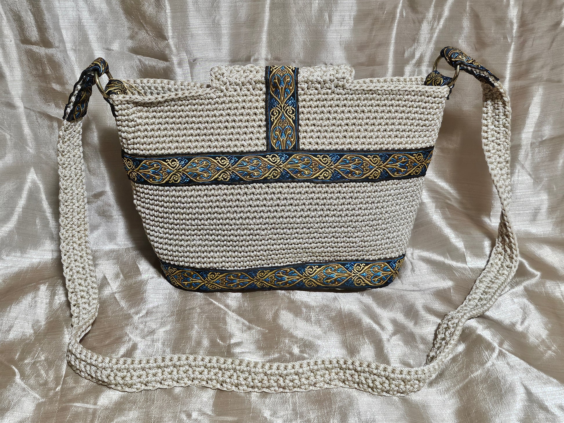 Back view of Cream coloured crochet handbag with Teal and Gold paisley trim