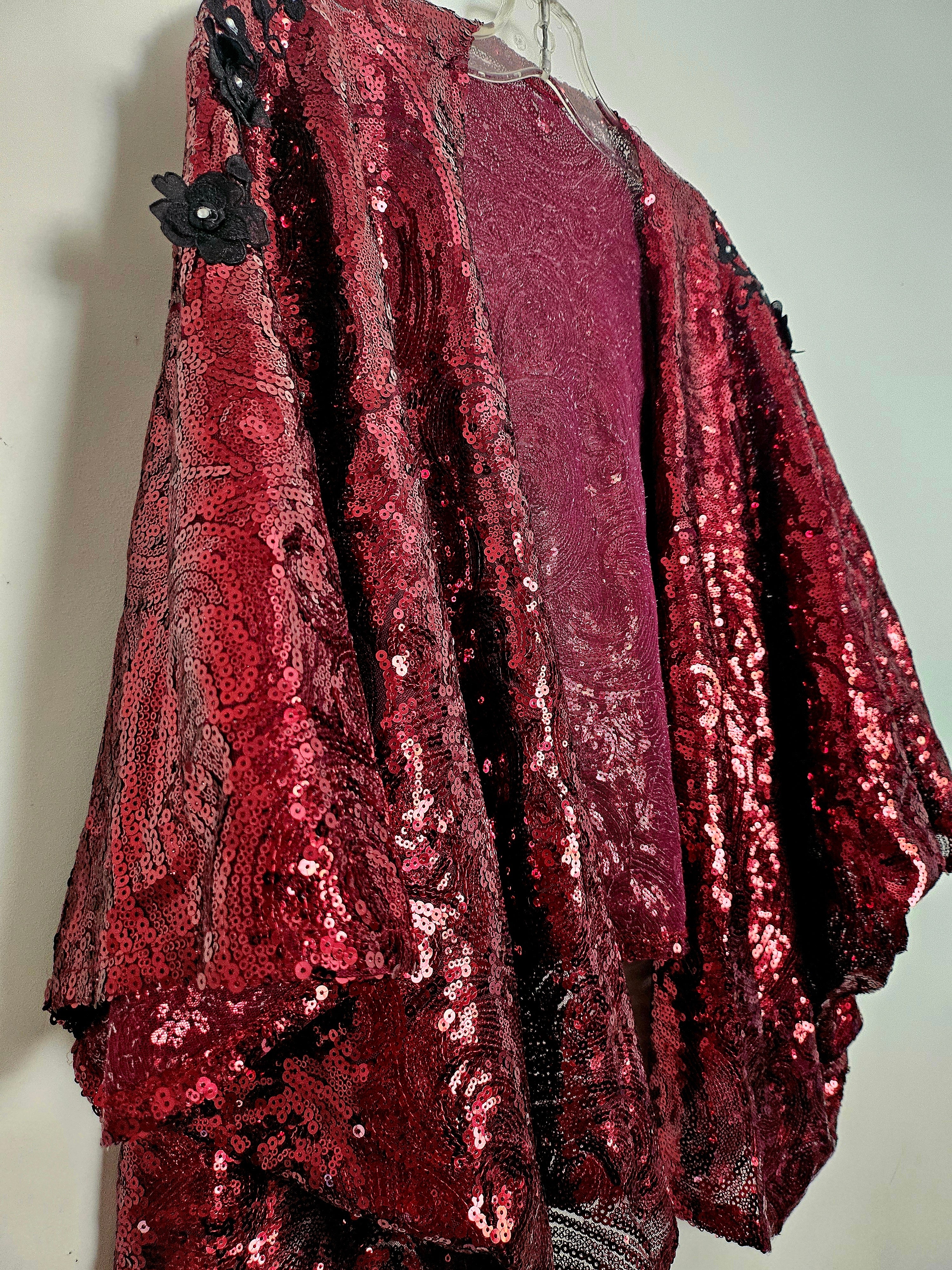 side view of Burgundy sequin kimono jacket with black embroidered shoulders on hanger