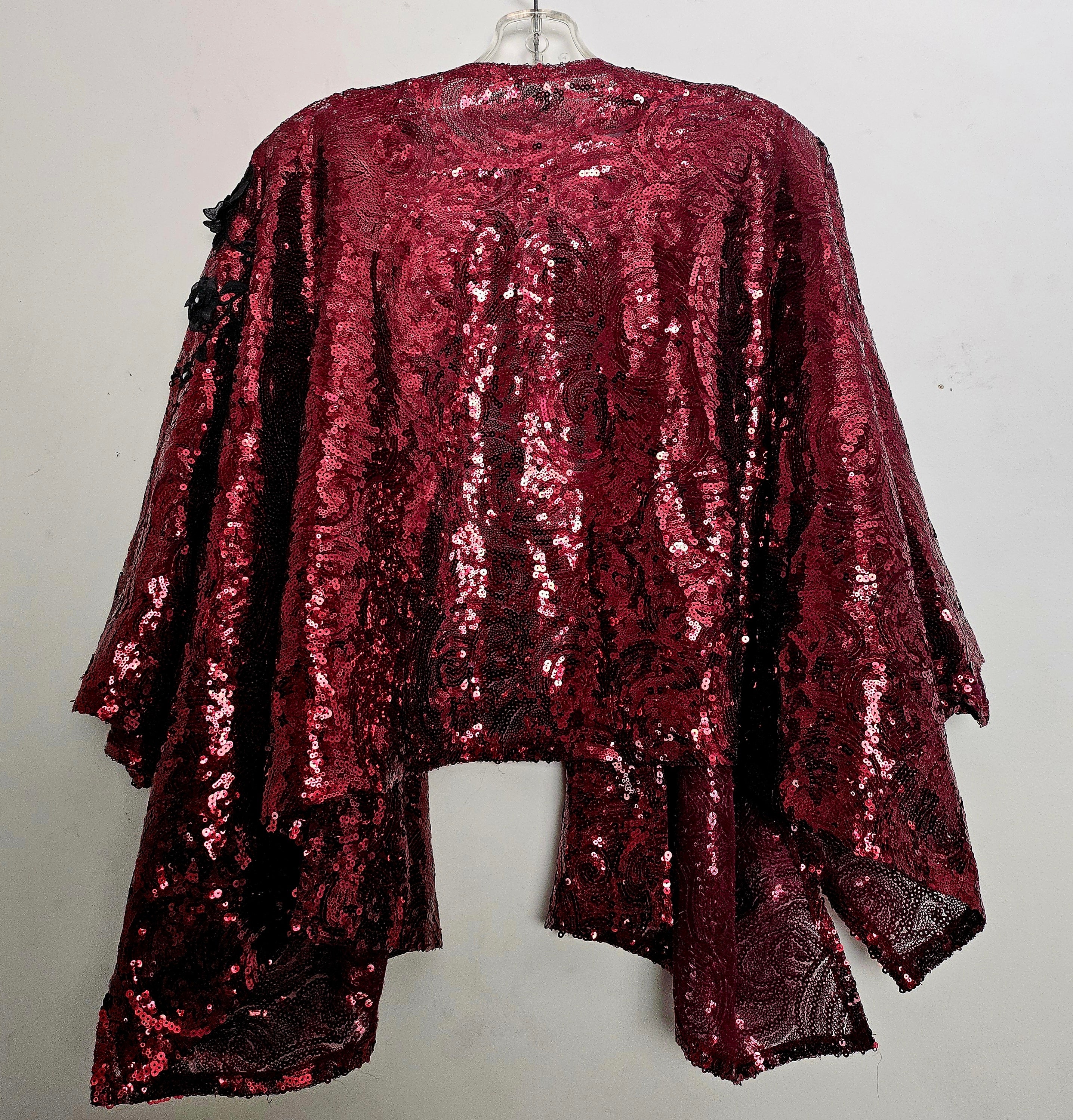 back view of Burgundy sequin kimono jacket with black embroidered shoulders on hanger