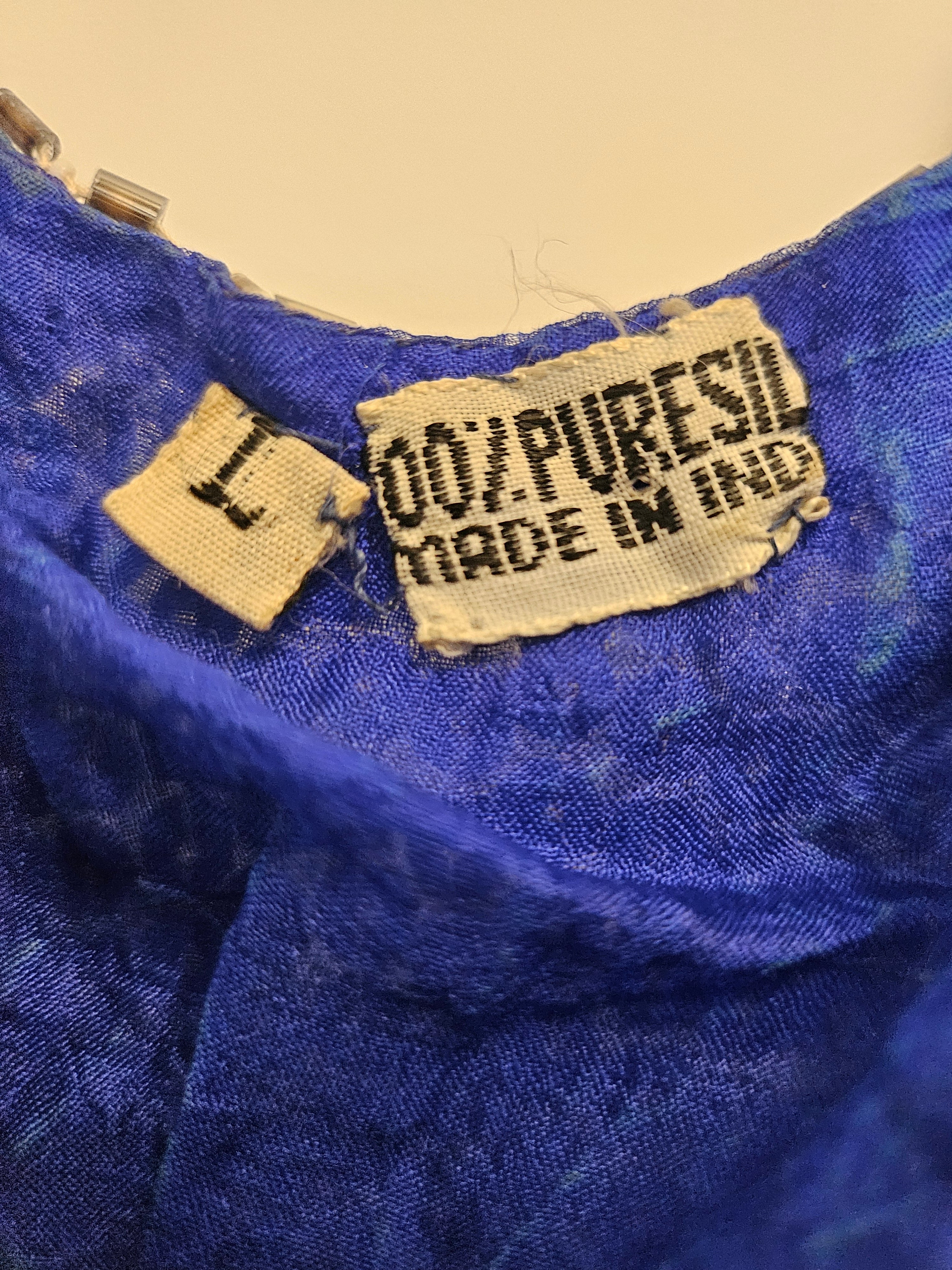 Close up view of labels of vintage 80s Blue and Silver Sequin Gown
