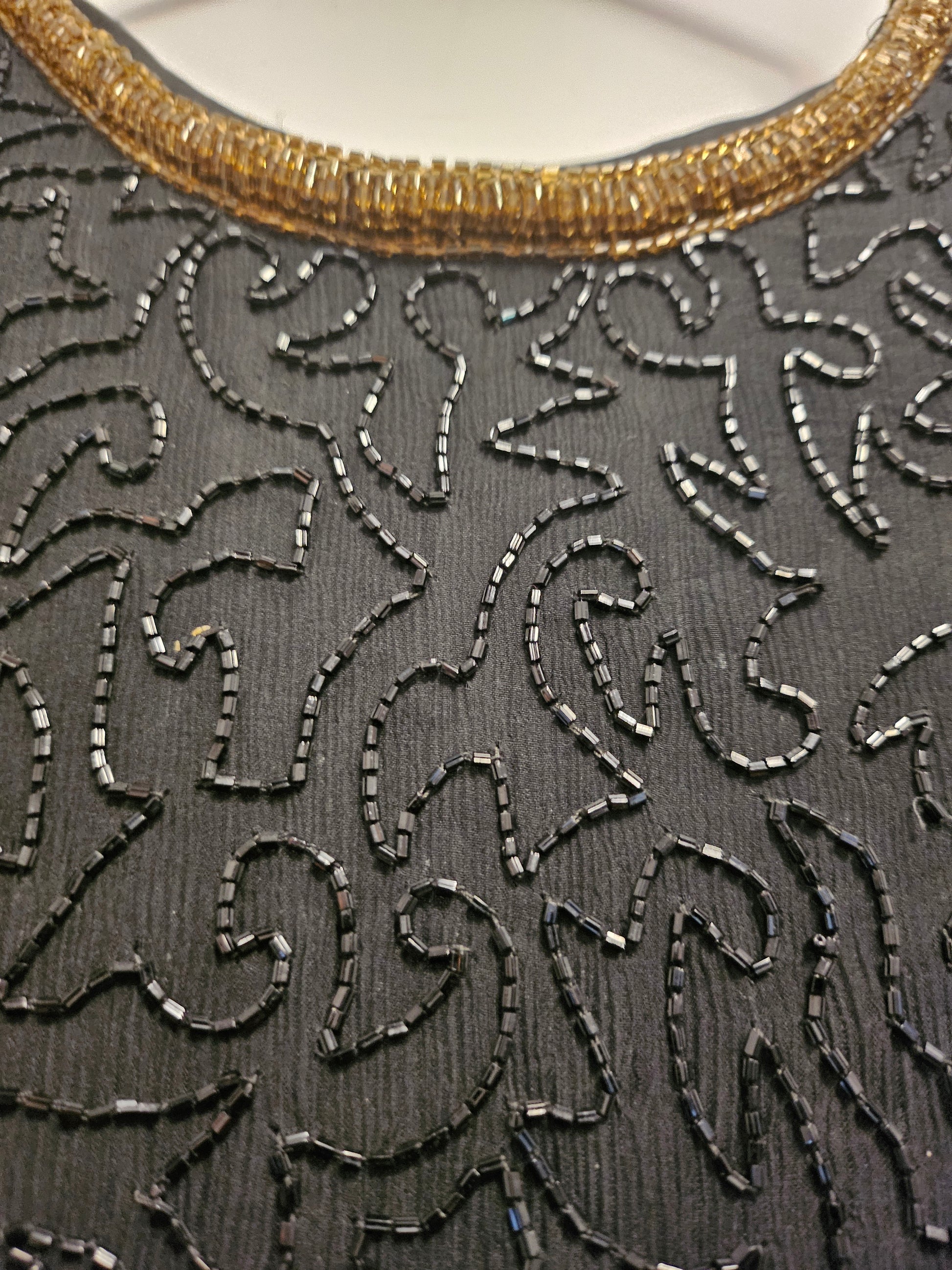 Close up view of 80s Black and Gold Beaded Cocktail Dress