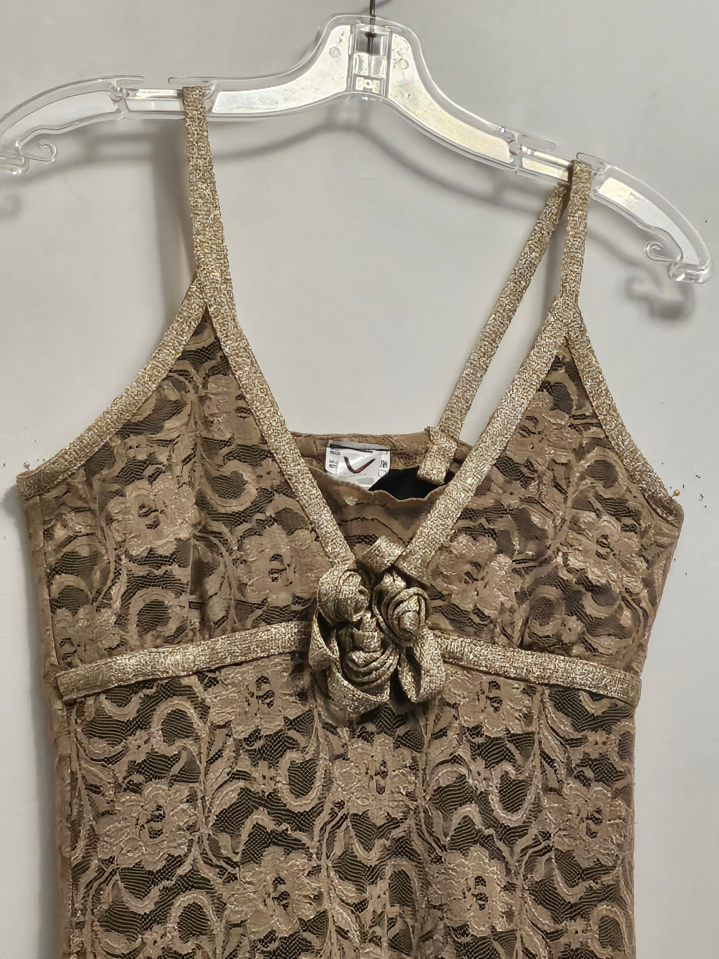 Close up of Front view of Lace Cocktail Dress with golden trim rose detail