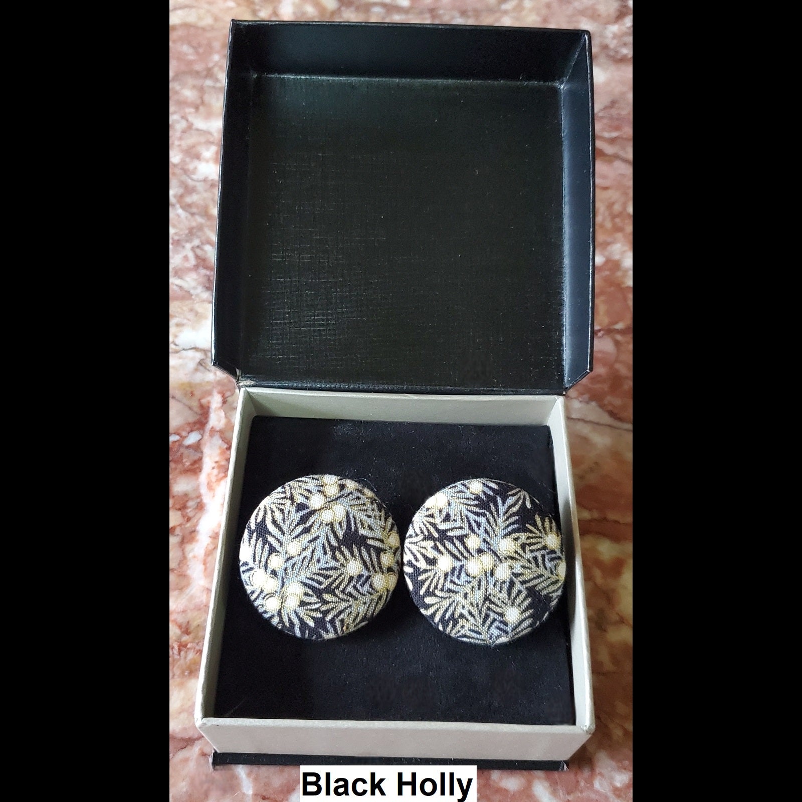Black holly print button earrings in jewelry box