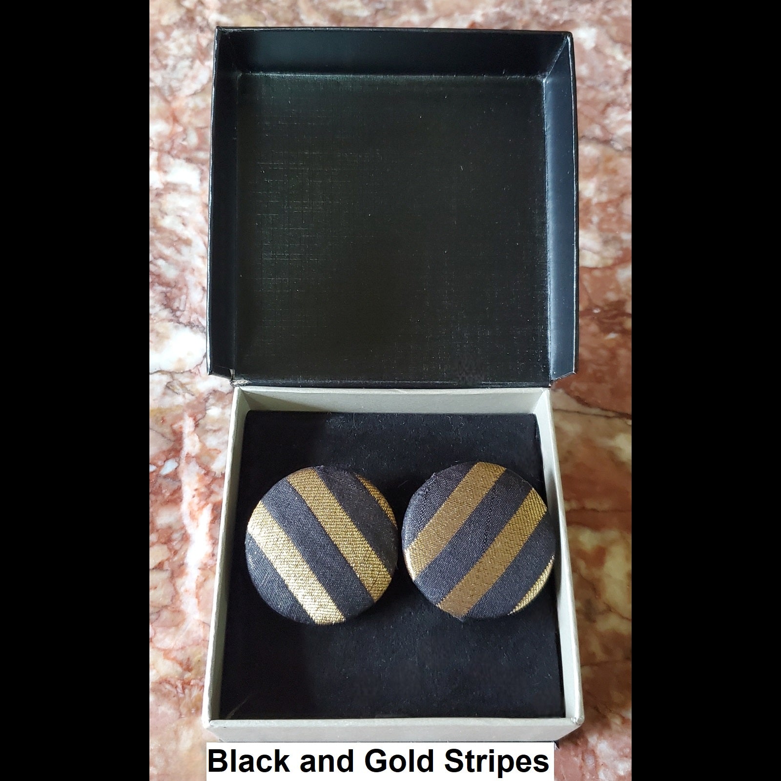 Black and gold stripe button earrings in jewelry box 