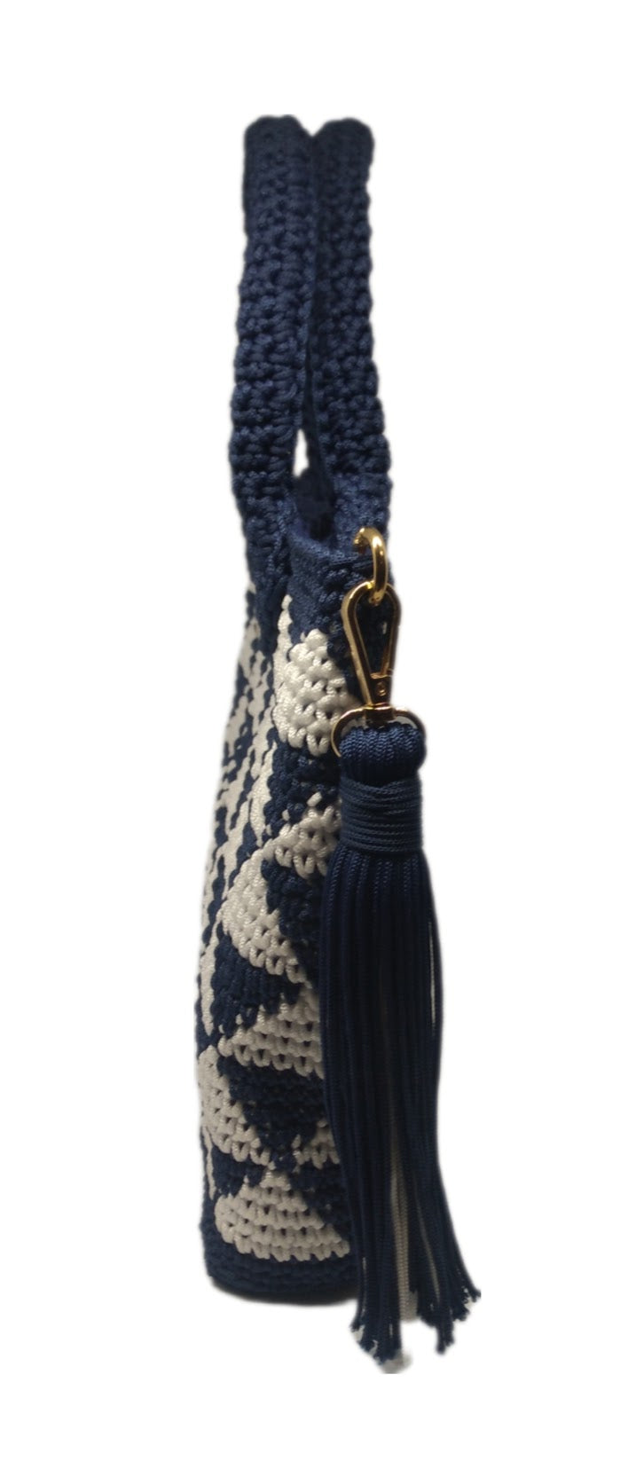 side view of Blue and white crochet geo print handbag with large tassel