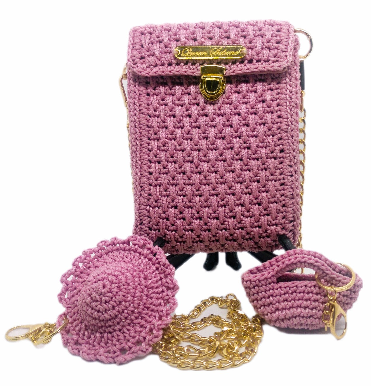 Front view of pink crochet crossbody bag, hat and purse keychains