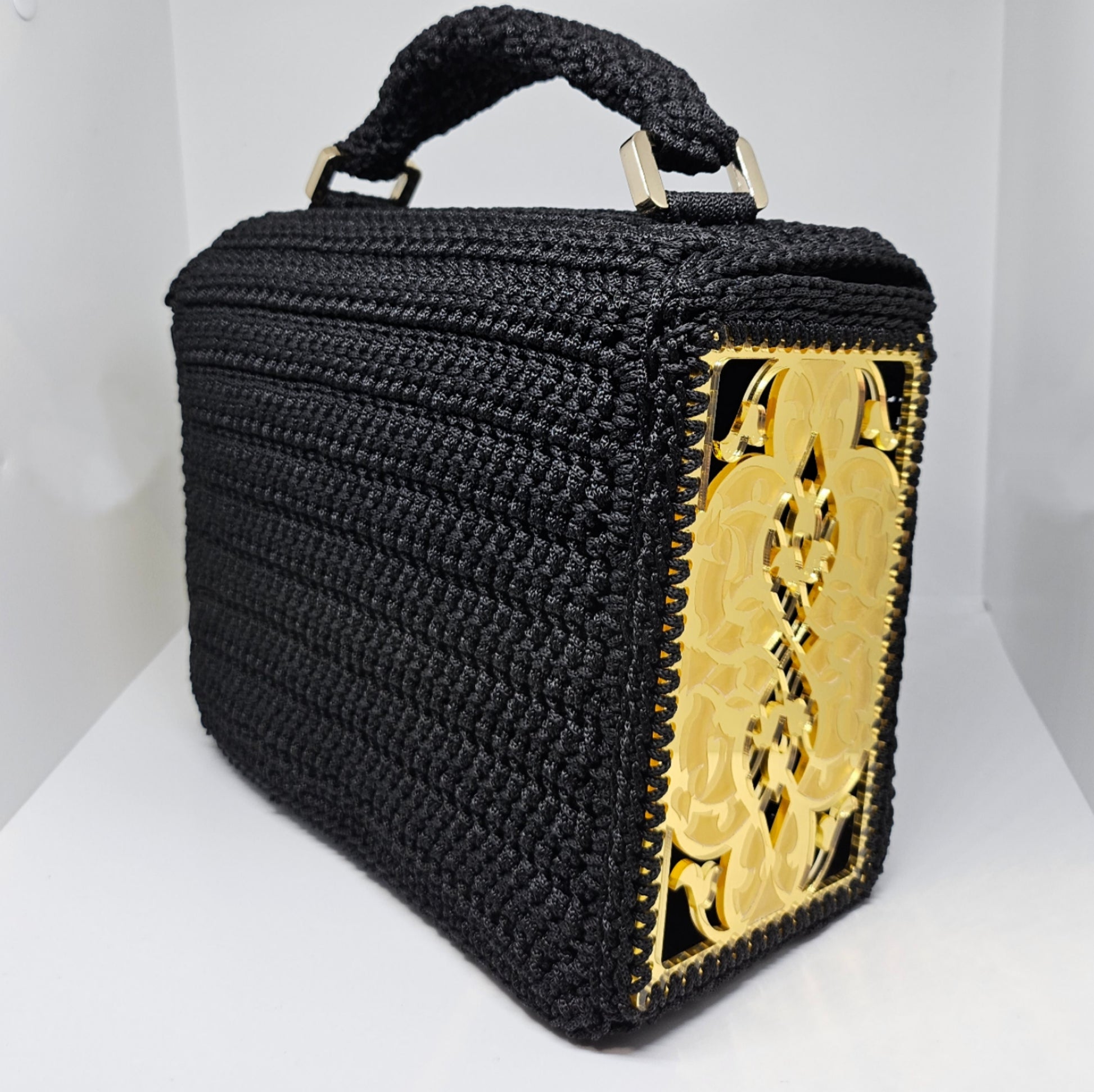 Side back view of Structured black crochet handbag with custom made laser cut acrylic sides