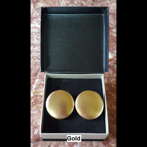 Gold button earrings in jewelry box