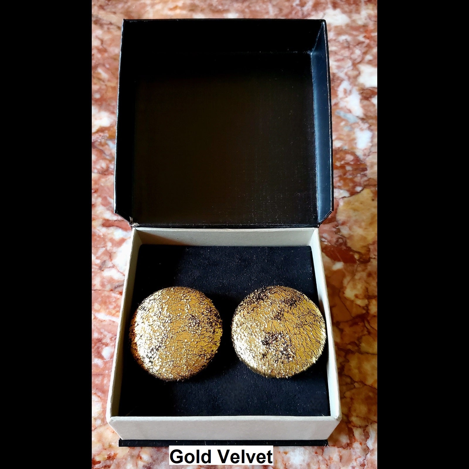 Gold velvet button earrings in jewelry box 