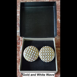 Gold and white wave print button earrings in jewelry box
