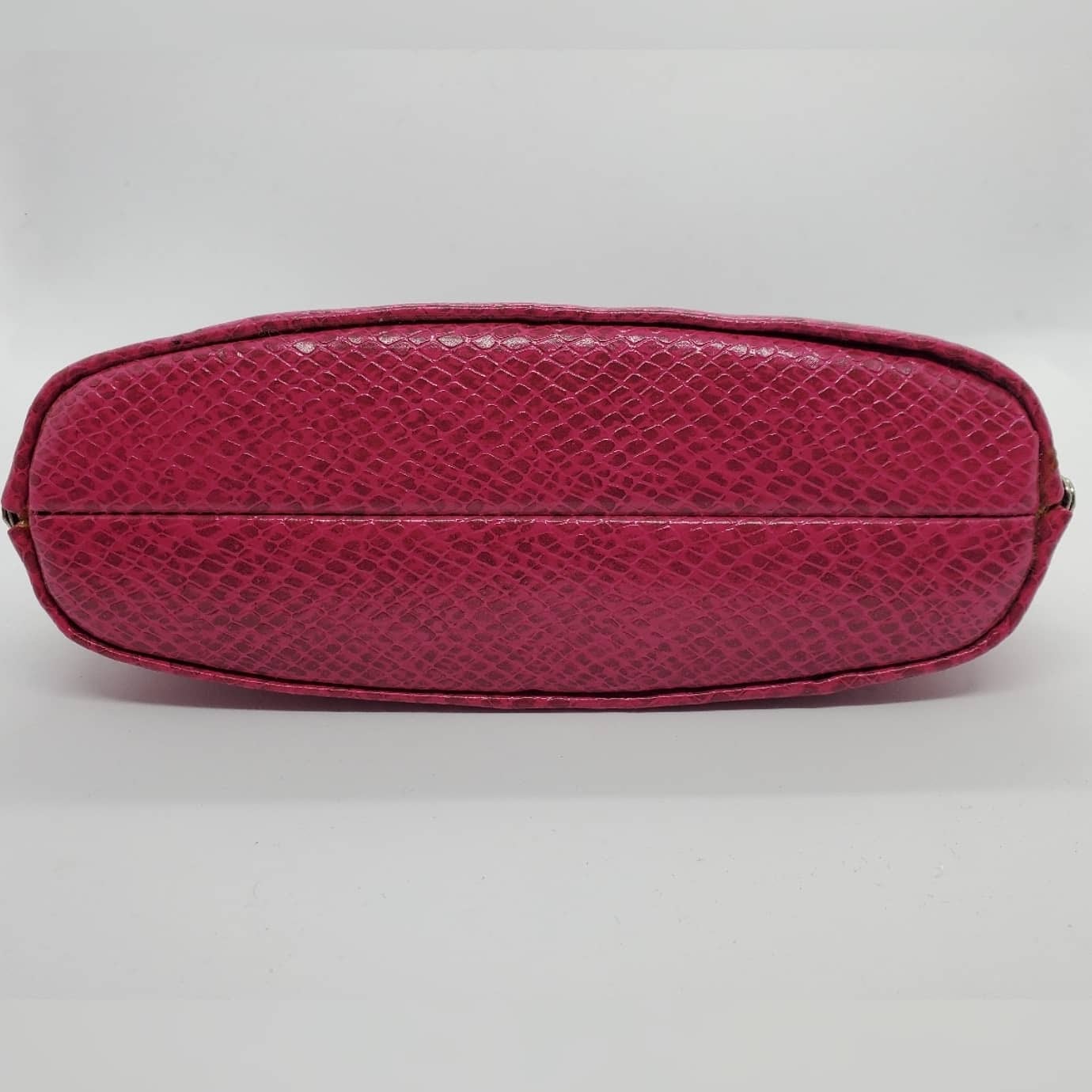 bottom view of hot pink snakeskin print handbag