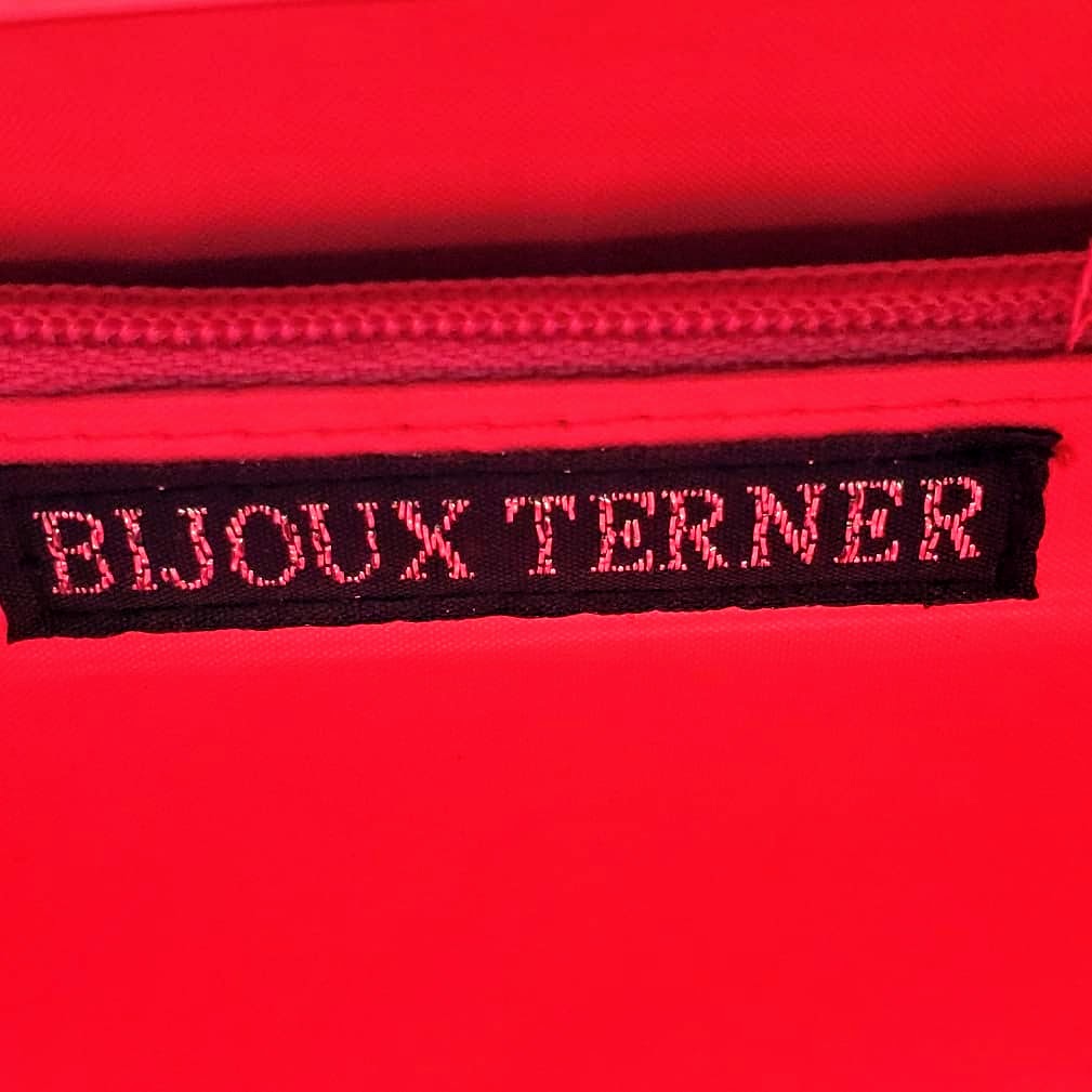 label of hot pink snakeskin print handbag