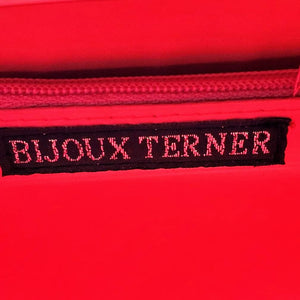 label of hot pink snakeskin print handbag