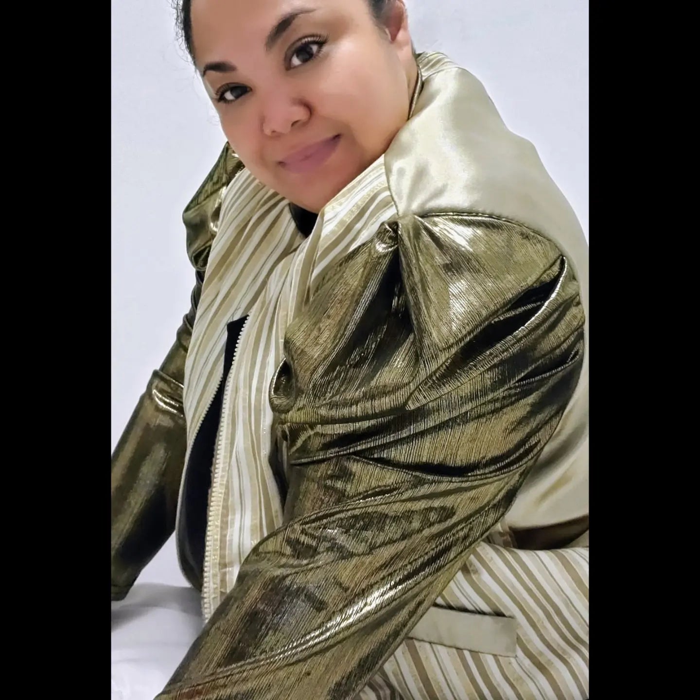 Gold and ivory striped bomber jacket with gigot sleeves on model
