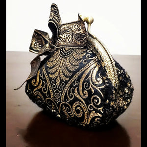 Side view of platinum and black paisley brocade coin purse with matching paisley bow accent