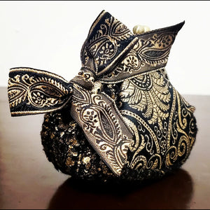 Side view of platinum and black paisley brocade coin purse with matching paisley bow accent