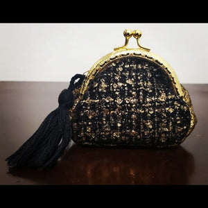 Front view of Gold and black tweed kiss clasp coin purse with tassel