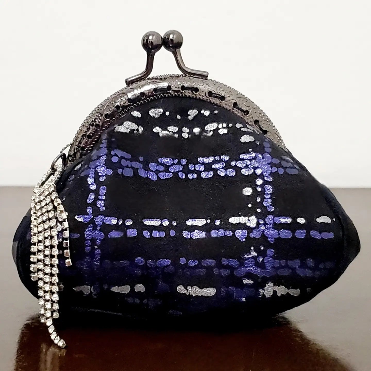 Front view of Purple and silver plaid kiss clasp coin purse with rhinestone tassel