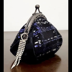 Side view of Purple and silver plaid kiss clasp coin purse with rhinestone tassel