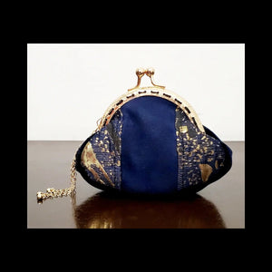 Front view of Blue and gold kiss clasp coin purse with gold tassel 