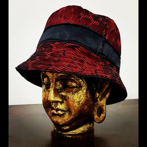 Side view of reversible red and black brocade bucket hat