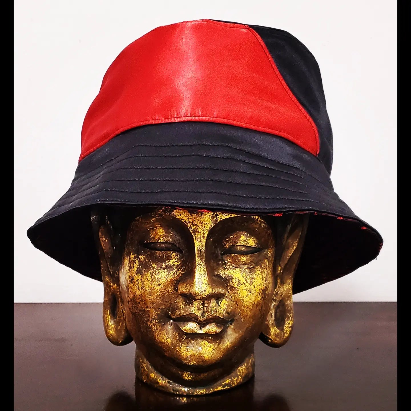 Reversed Front view of reversible red and black brocade bucket hat
