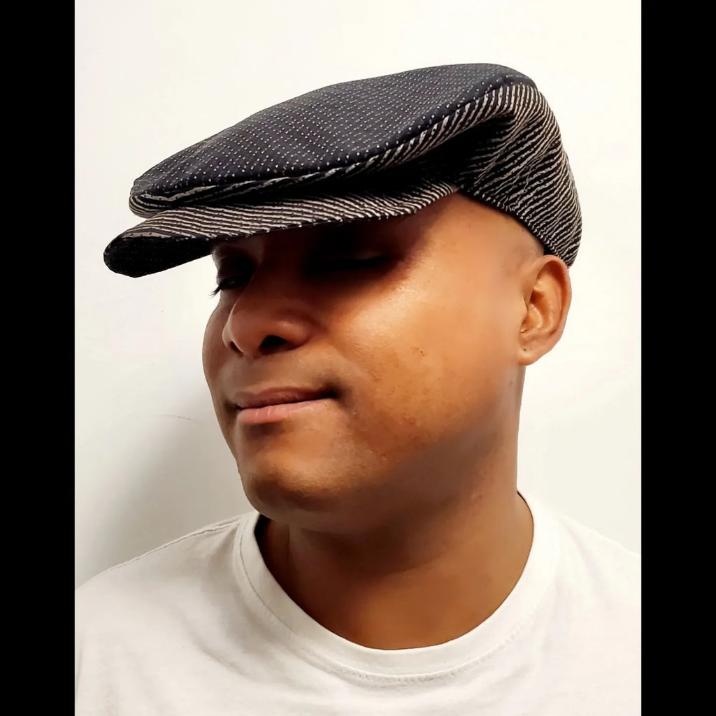 Brown and black swiss dot and striped flat cap on male model