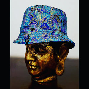 Reversed side view of Teal blue reversible leaf and peacock printed bucket hat