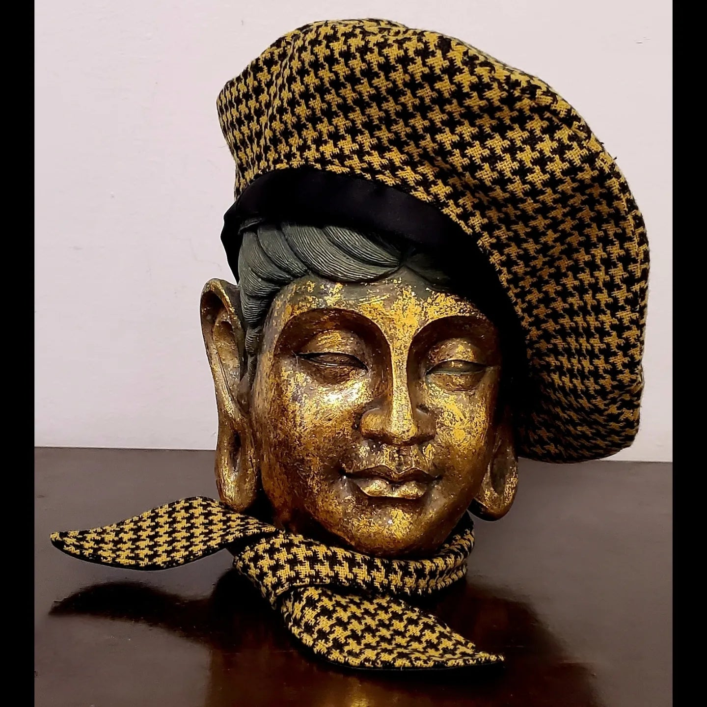 Yellow and black houndstooth beret and matching scarf on mannequin head