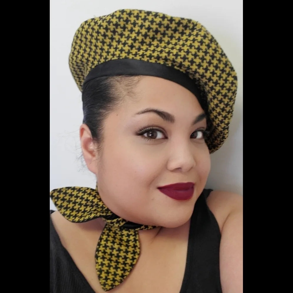 Yellow and black houndstooth beret and matching scarf on model