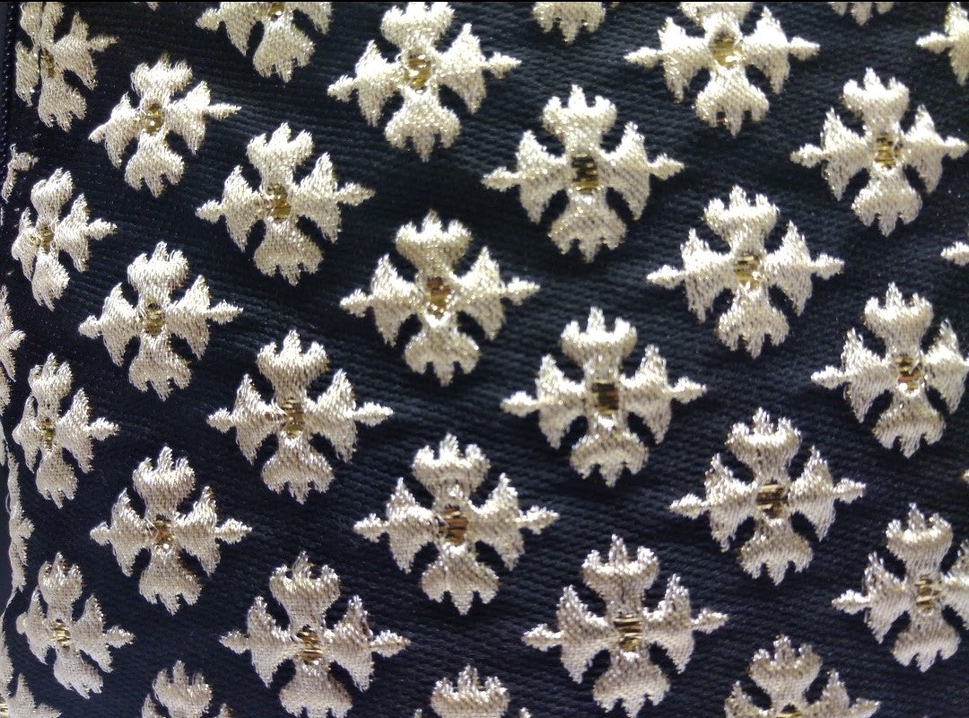 Close up view of old crosses on black brocade. 