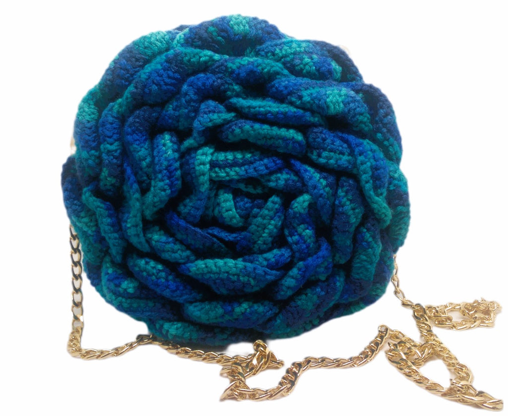 Front view of variegated blue and teal 3D Floral crochet handbag and gold chain strap.