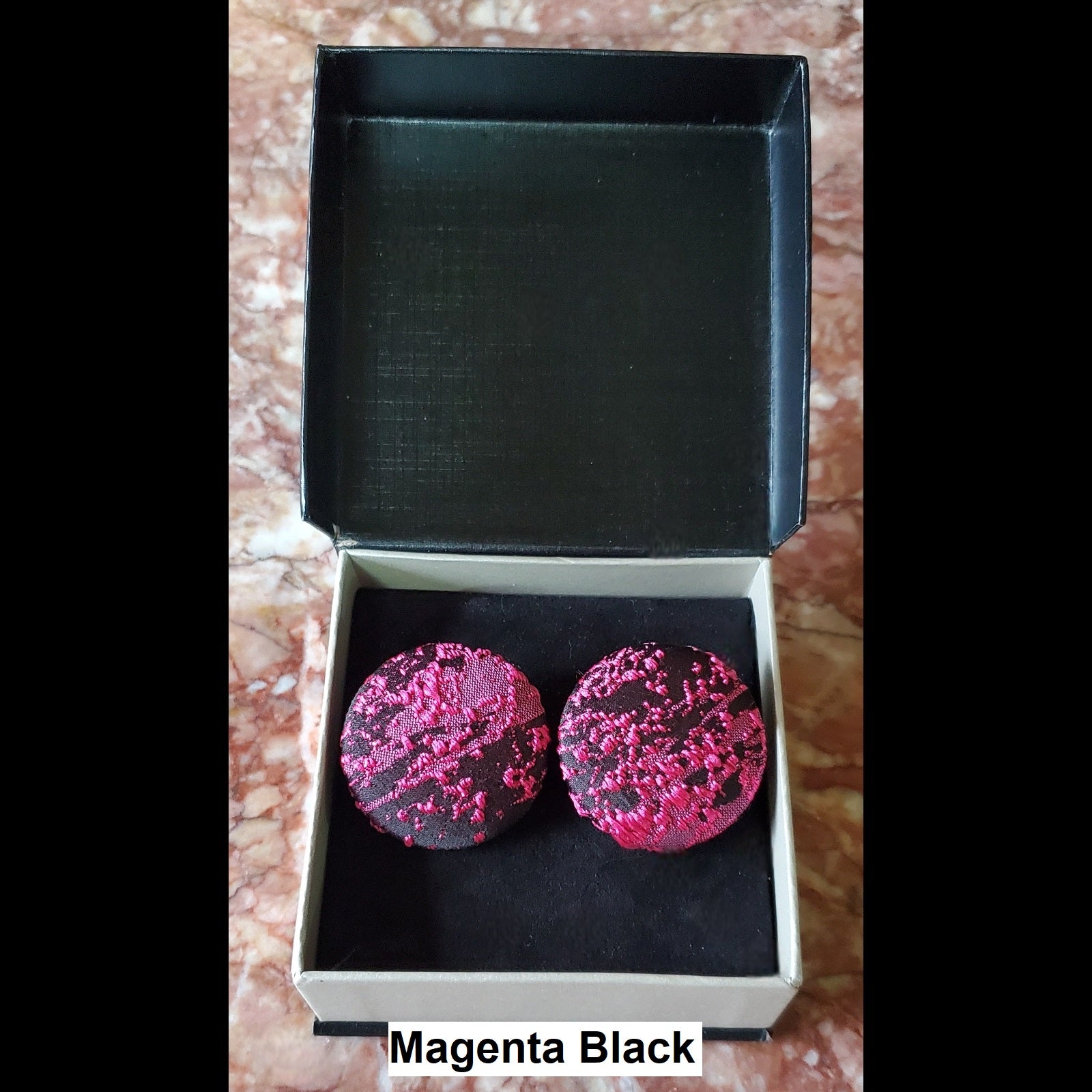 Magenta and black button earrings in jewelry box 