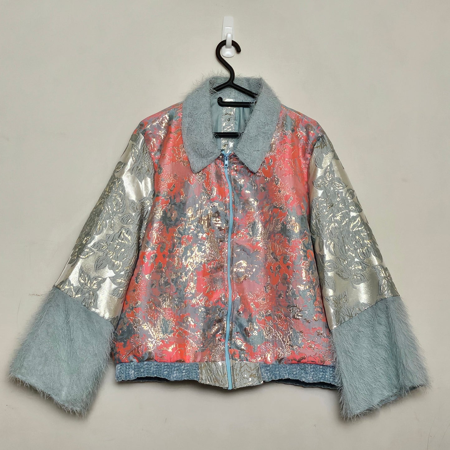 Front view of Coral and mint jacket with fringe cuffed sleeves