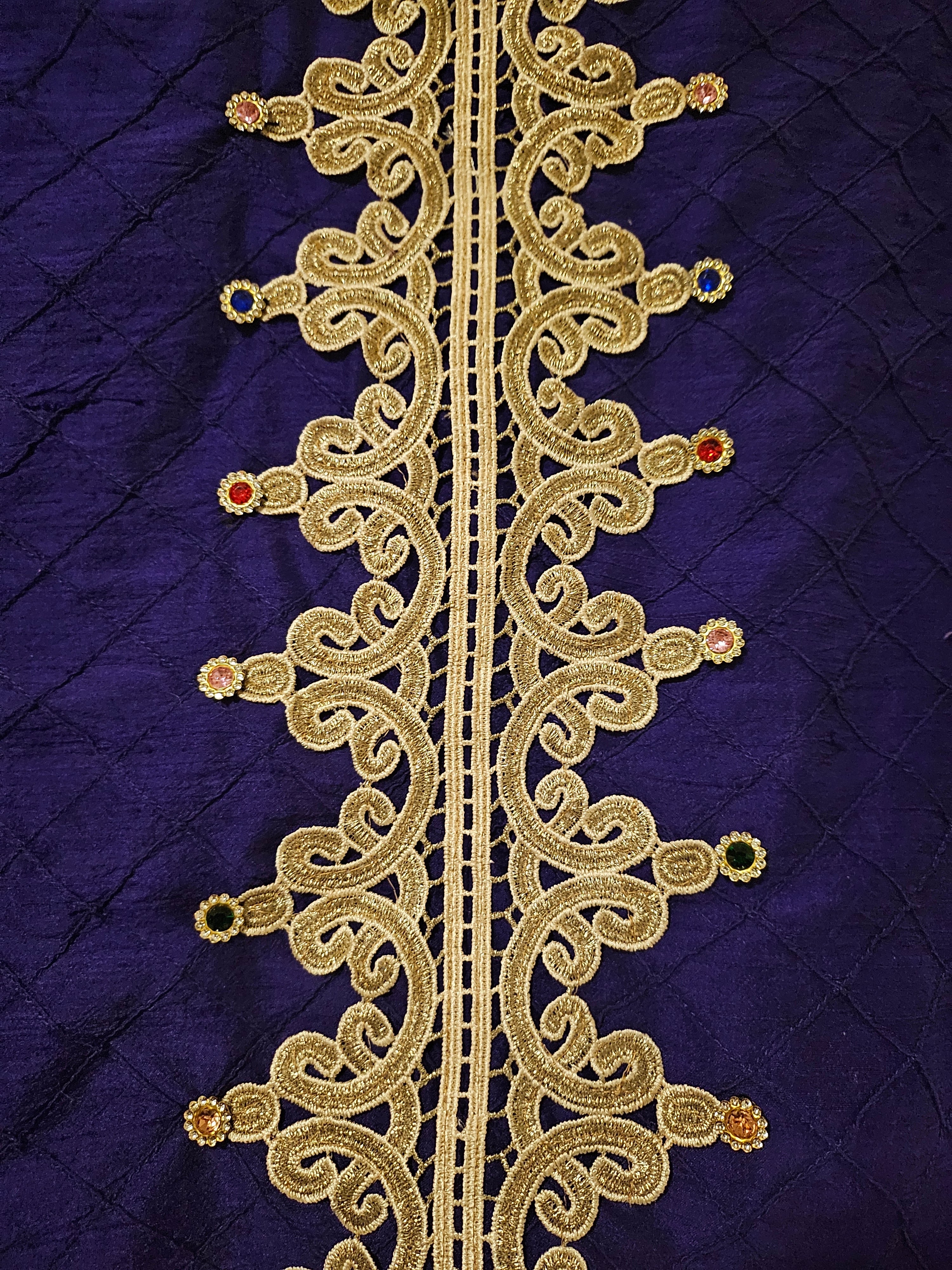 close up view of back details of Rhinestone encrusted purple silk bomber jacket with gold lace accents