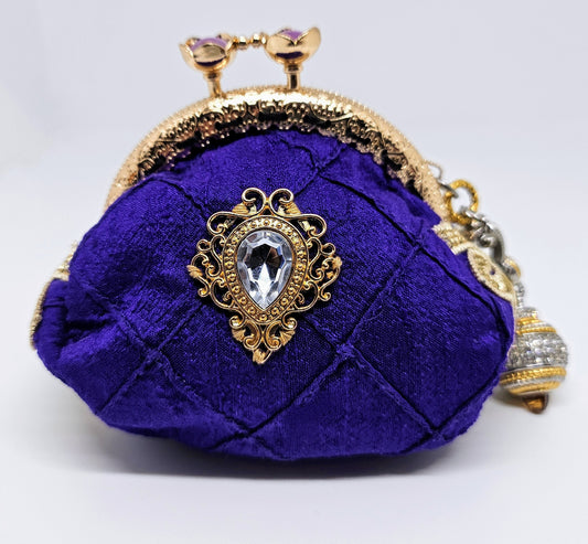 Front view of Pintuck purple silk kiss clasp coin purse decorated with rhinestone filigree accents