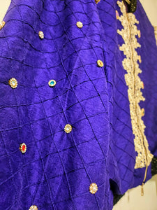 close up of sleeves of Rhinestone encrusted purple silk bomber jacket with gold lace accents