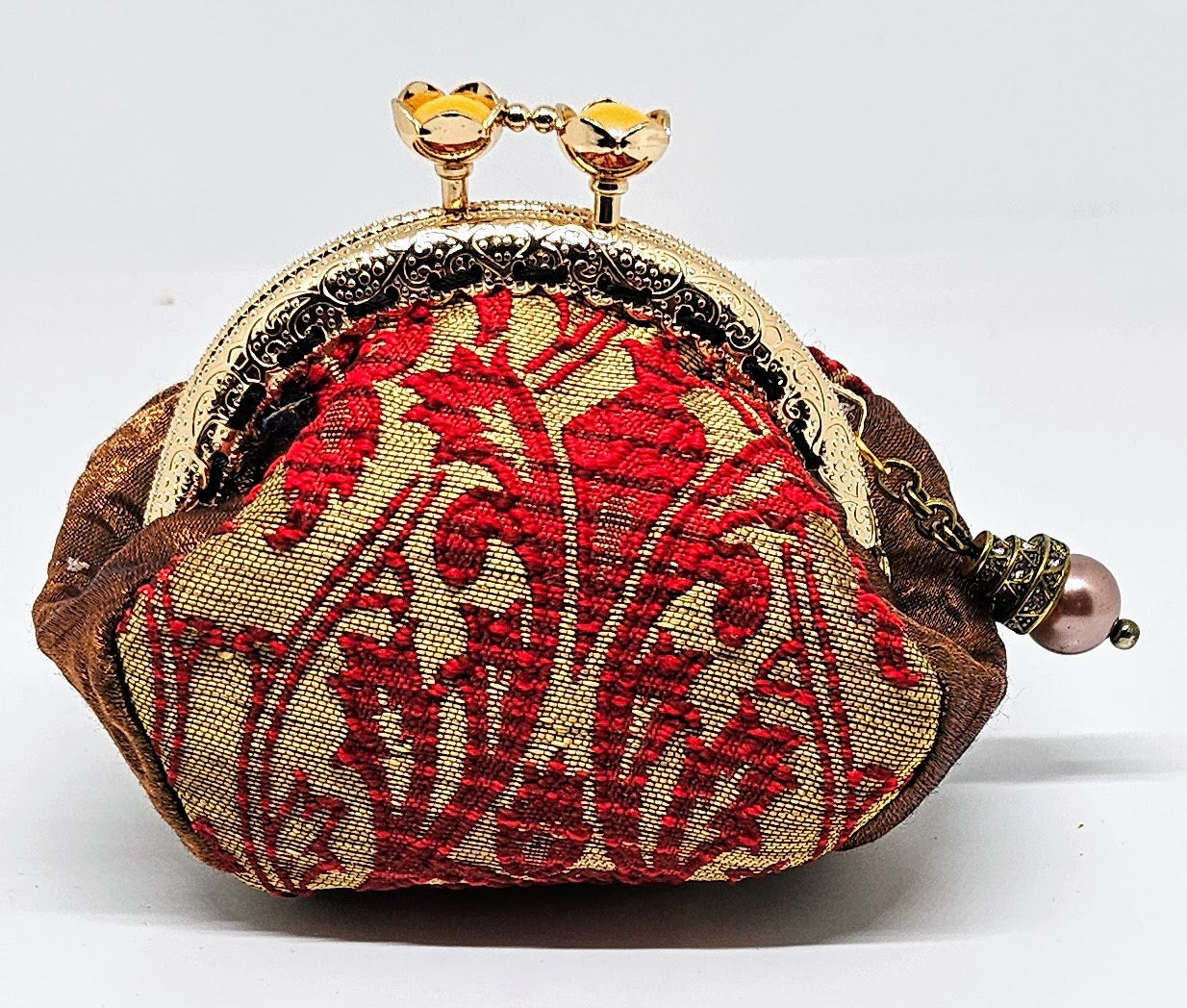 Front view of Baroque print kiss clasp coin purse with ornate jeweled pearl charm. 