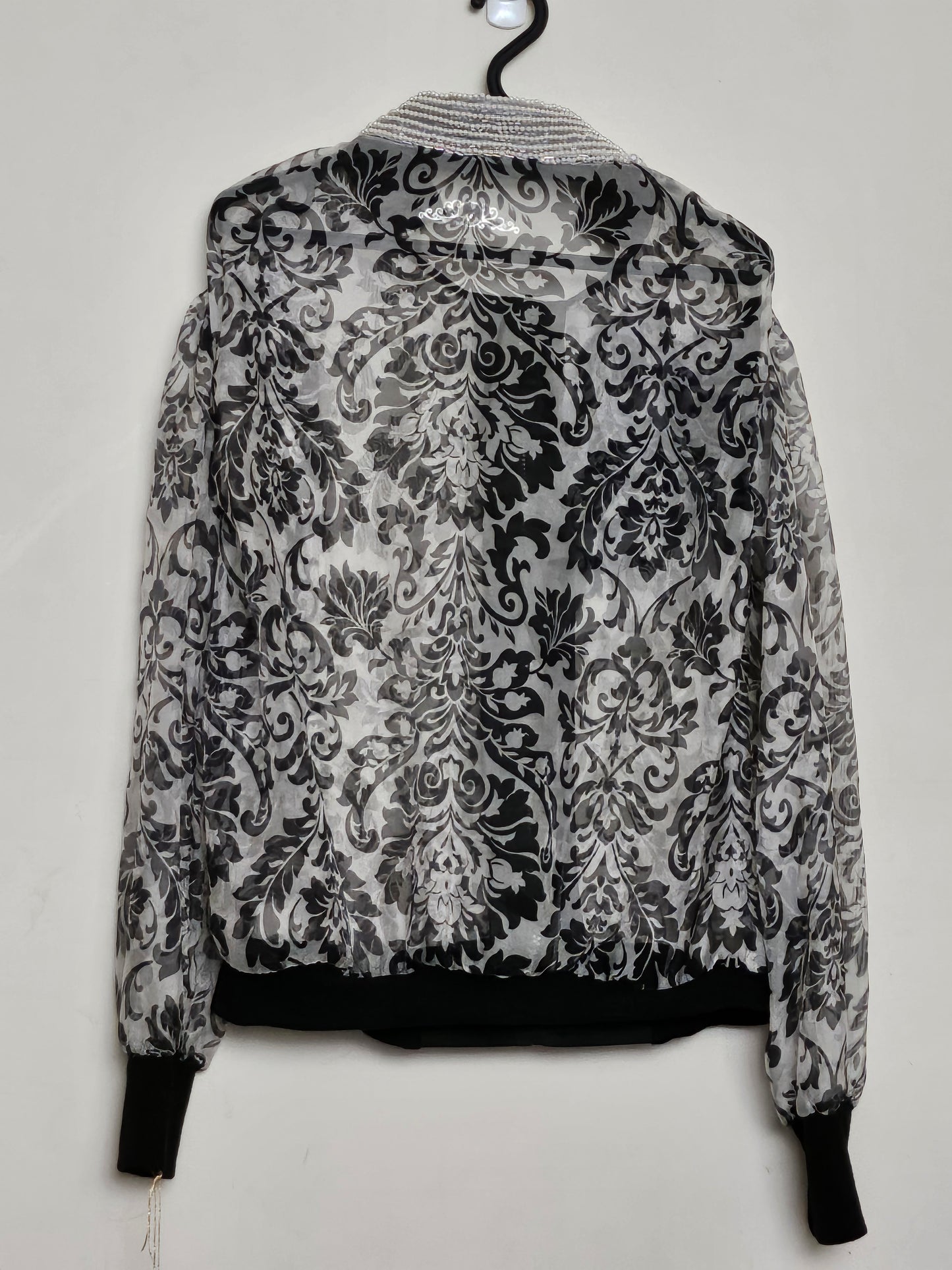 Back view of Sheer damask print bomber jacket with pearl and floral accents