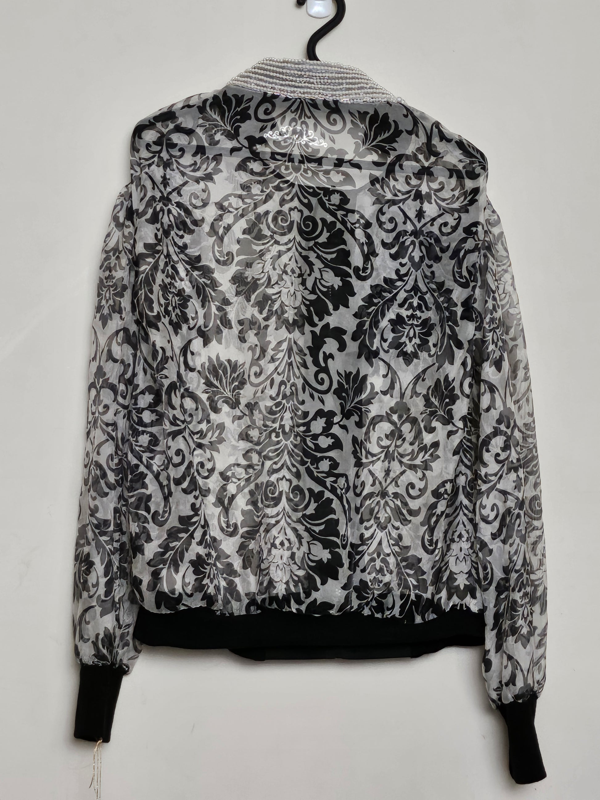 Back view of Sheer damask print bomber jacket with pearl and floral accents