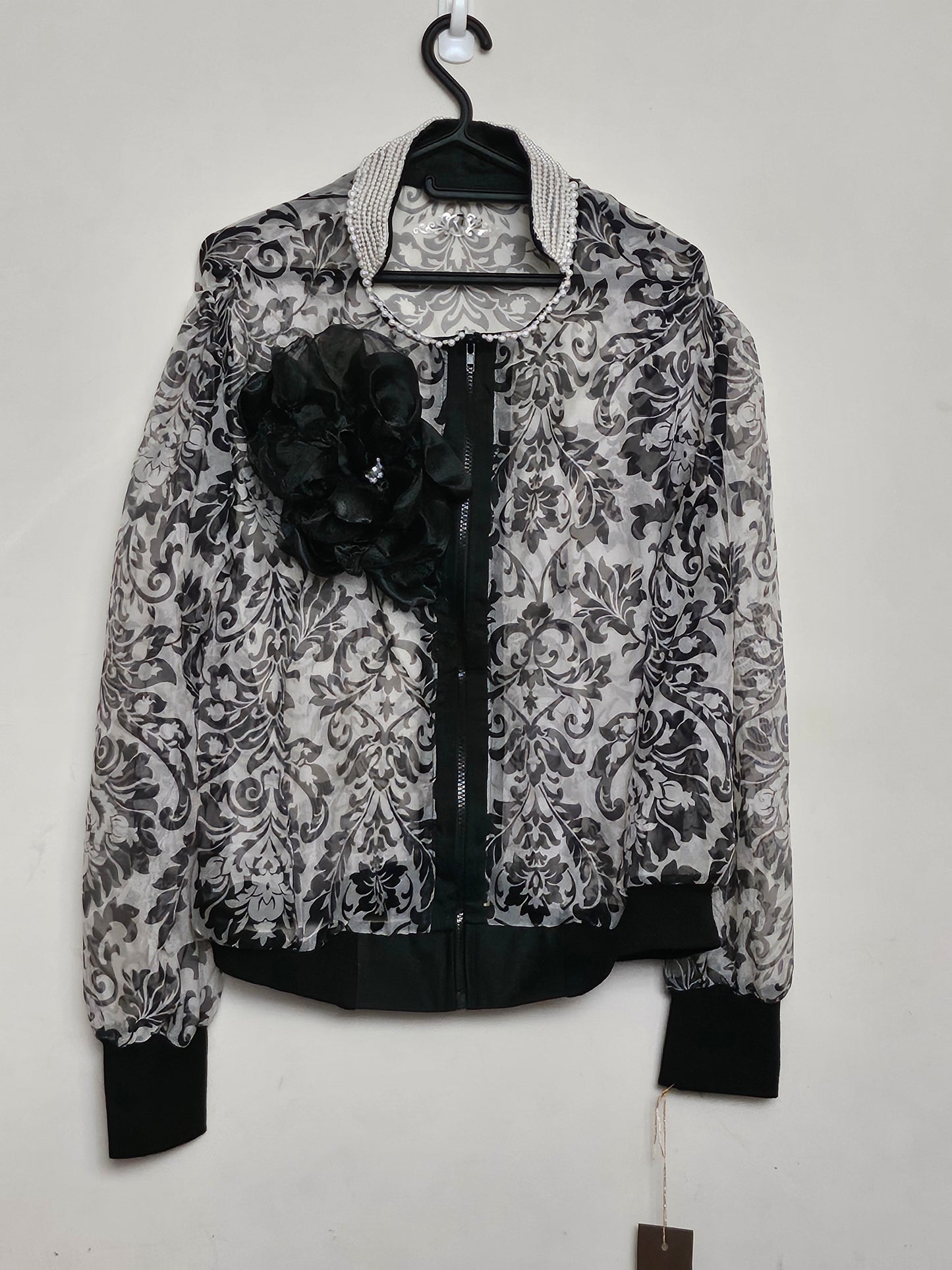 Front view of Sheer damask print bomber jacket with pearl and floral accents