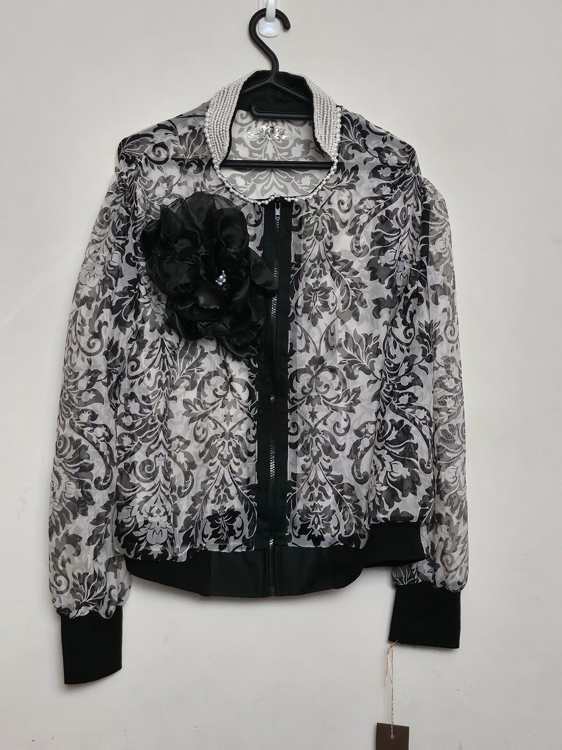 Front view of Sheer damask print bomber jacket with pearl and floral accents